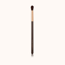 Load image into Gallery viewer, A precise eye crease makeup brush with a rose gold ferrule with a dark brown lacquered handle, made using handcrafted synthetic dark brown bristles mixed with a few strands of white bristles.
