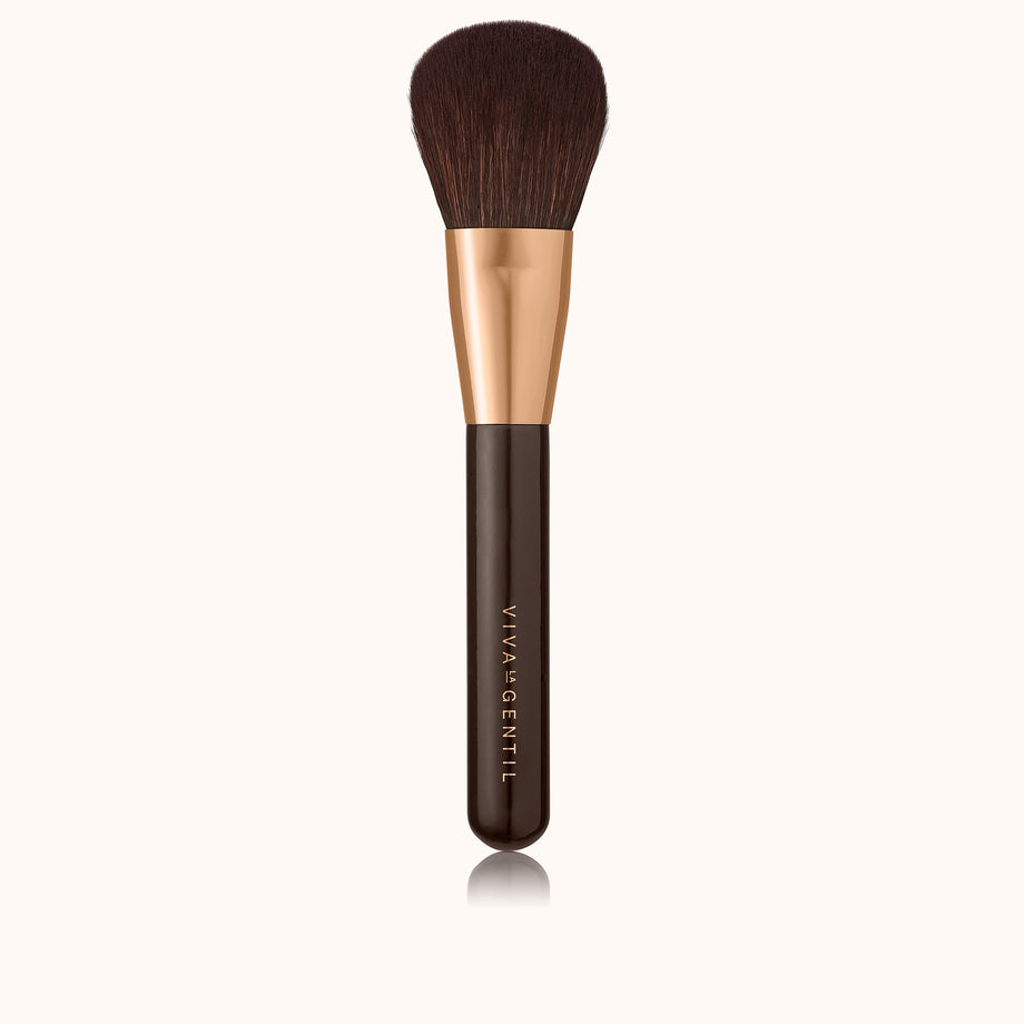 Large dome shaped makeup brush with a dark brown lacquered handle and a rose gold ferrule, made by mixing handmade synthetic dark brown bristles with a few strands of white bristles.