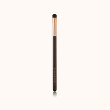 Load image into Gallery viewer, A soft, curved dome-shaped short makeup brush with a dark brown lacquered handle and a rose gold ferrule, made by mixing handmade synthetic dark brown bristles with a few strands of white bristles.
