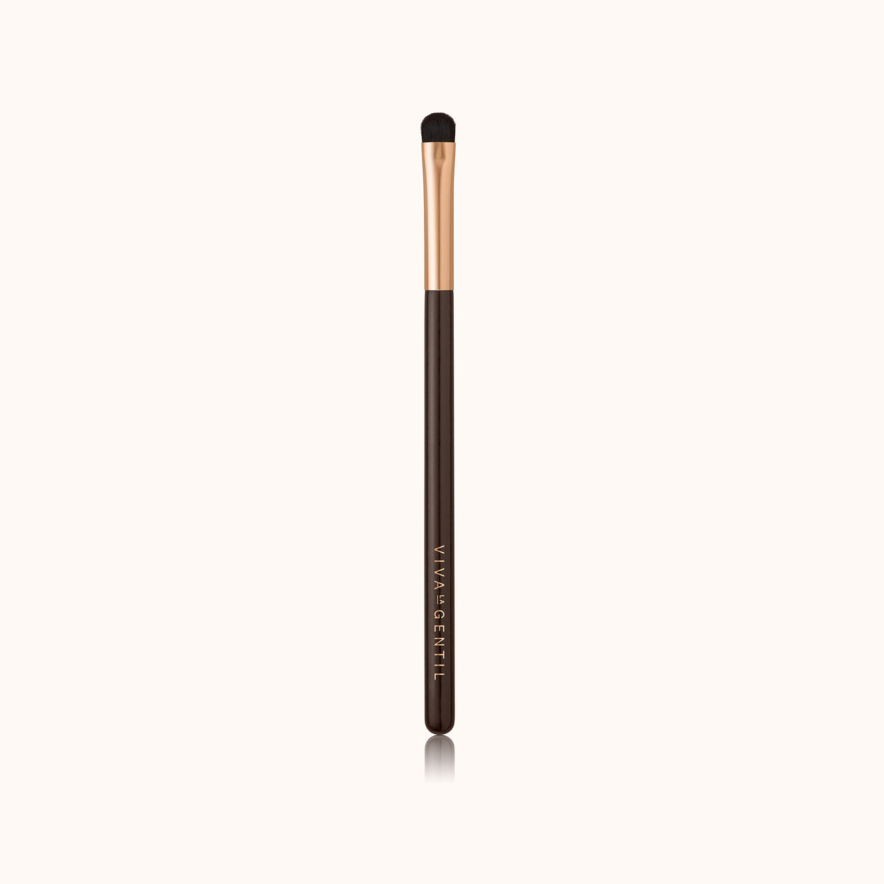 A soft, curved dome-shaped short makeup brush with a dark brown lacquered handle and a rose gold ferrule, made by mixing handmade synthetic dark brown bristles with a few strands of white bristles.