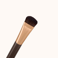 Load image into Gallery viewer, A soft curved thin makeup brush with a dark brown lacquered handle and a rose gold ferrule, made by mixing handmade synthetic dark brown bristles with a few strands of white bristles.
